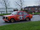 Red Ford Escort sidways around corner